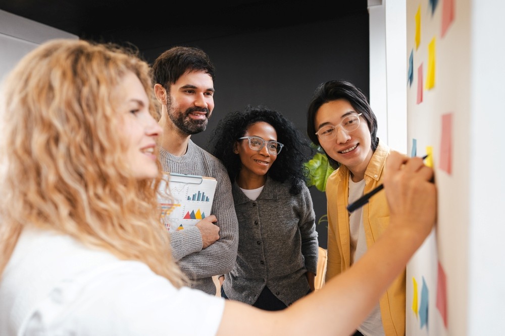 Groupe de collègues de différentes origines ethniques collaborant et partageant des idées lors d'une réunion d'affaires